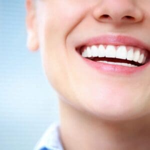 A close up of a person 's smile with white teeth.