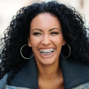 A woman with curly hair and big smile.