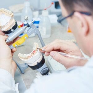 A man is working on something in his mouth.